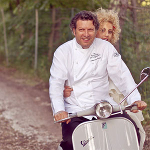 Wedding in Umbria Vespa Club. The Chef Giancarlo Polito in Vespa with the bride. Montone, Perugia, Umbria, Italy